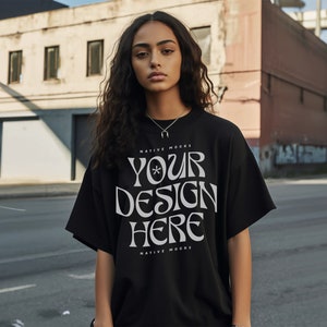 May include: A black t-shirt with the text "YOUR DESIGN HERE" in white lettering. The shirt is worn by a person with long dark hair. The text is in a stylized font with a star symbol.