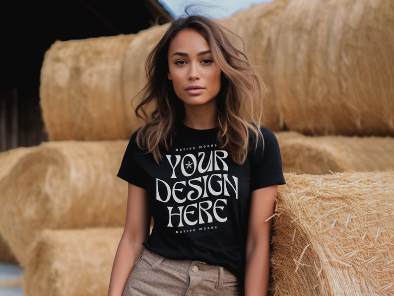 May include: A woman wearing a black t-shirt with the text "YOUR DESIGN HERE" in white. The shirt is a mock-up for a design and has the text "NATIVE MOCKS" above and below the design area.