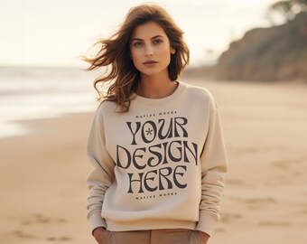 May include: A beige sweatshirt with the text "YOUR DESIGN HERE" in a retro font. The text is surrounded by the words "NATIVE MOCKS" at the top and bottom.