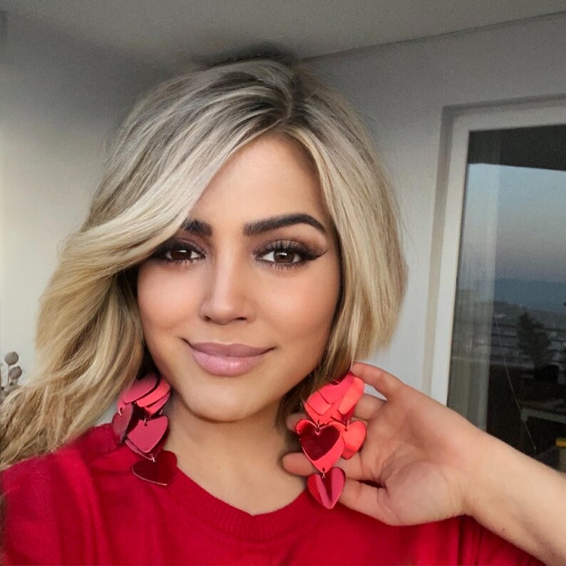 Handmade red heart layered leather statement earrings with a bold and shiny finish, perfect for Valentine’s Day and gift giving.