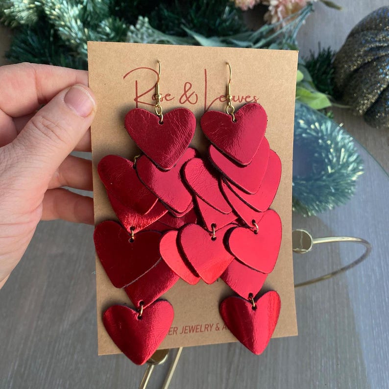 Handcrafted cascading red heart earrings featuring the Love Bomb design, perfect for parties and celebrations.