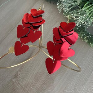 Lightweight layered-heart earrings in vibrant red leather, offering bold style without heaviness.