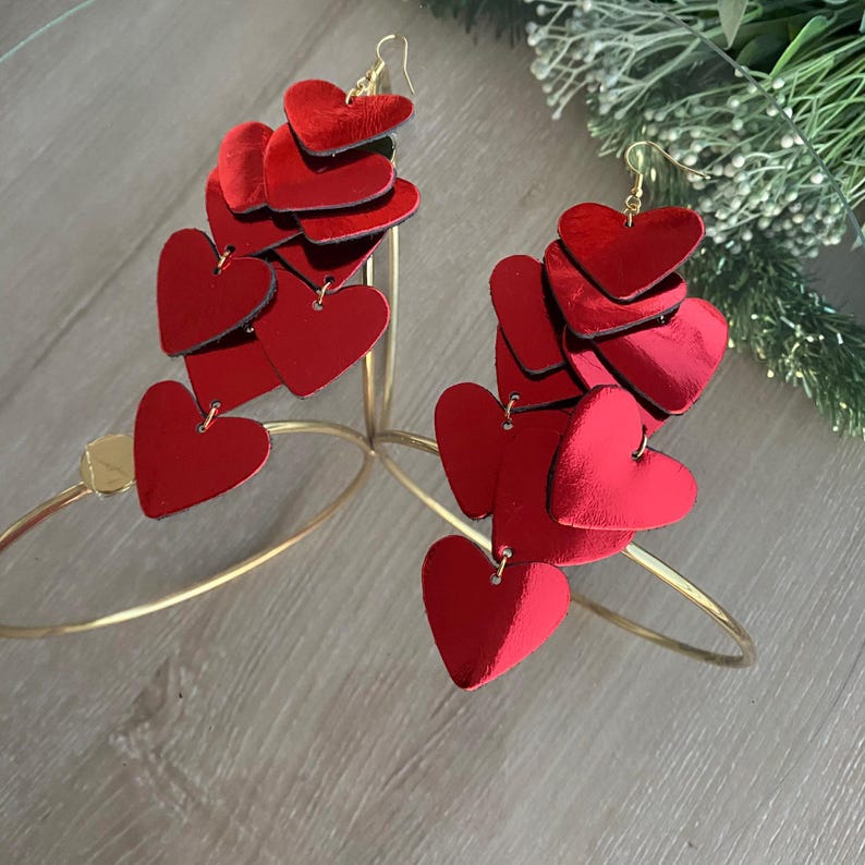 Lightweight layered-heart earrings in vibrant red leather, offering bold style without heaviness.