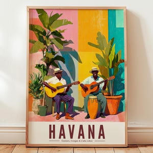 May include: A framed print showcasing two musicians playing guitars and a conga drum in Havana, Cuba. The artwork uses a vibrant palette of pink, yellow, and teal, with green plants. The word "HAVANA" is displayed in bold letters.