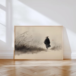 May include: A framed ink wash painting on a light beige background depicting a solitary figure wearing a conical hat and dark robes walking through tall, wispy grasses. A small red square seal is visible near the figure in this artwork.