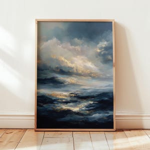 May include: An abstract painting of a cloudy sky in shades of blue, white, and gold, framed in a light wood. The artwork depicts a dramatic sky with swirling clouds and a sense of depth, evoking a serene yet powerful atmosphere.