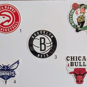 May include: A collection of ten NBA team logos, including the Atlanta Hawks, Boston Celtics, Brooklyn Nets, Charlotte Hornets, and Chicago Bulls. The logos are printed on white paper with black numbers indicating their order.