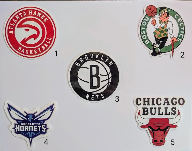 May include: A collection of ten NBA team logos, including the Atlanta Hawks, Boston Celtics, Brooklyn Nets, Charlotte Hornets, and Chicago Bulls. The logos are printed on white paper with black numbers indicating their order.