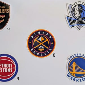May include: Ten different NBA team logos on a white background. The logos are for the Cleveland Cavaliers, Dallas Mavericks, Denver Nuggets, Detroit Pistons, Golden State Warriors.