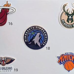 May include: A collection of 10 NBA team logos, including the Miami Heat, Milwaukee Bucks, Minnesota Timberwolves, New Orleans Pelicans, and New York Knicks.