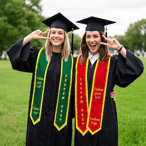 May include: Two graduates wearing black caps and gowns, each with a custom sash. One sash is green with yellow trim, the other is red with yellow trim. Text on the sashes reads "Custom your text" and "Custom Logo".