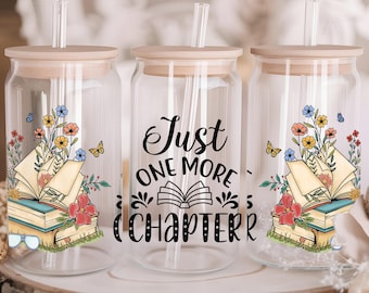 May include: Three clear glass tumblers with lids and straws. Each tumbler features a different design with a book, flowers, and butterflies. The middle tumbler has the text "Just One More Chapter".
