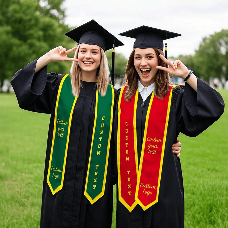 May include: Two graduates wearing black caps and gowns, each with a custom sash. One sash is green with yellow trim, the other is red with yellow trim. Text on the sashes reads "Custom your text" and "Custom Logo".