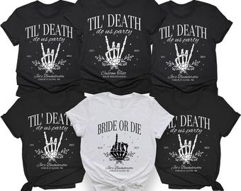 May include: A collection of five short-sleeved t-shirts. Four black shirts feature a white skeleton hand making a rock-and-roll gesture with the text TIL' DEATH do us party, EST. 2025, and Jet's Bachelorette COEUR D'ALENE, WA. One white shirt says BRIDE OR DIE.