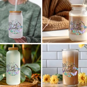 May include: Four glass bottles with a wooden lid and a straw. The bottles are filled with a light brown liquid and have a floral design with butterflies and the text "Just Breathe".