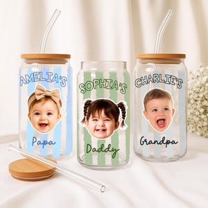 May include: Three glass tumblers with bamboo lids and clear straws. Each tumbler features a child's photo and a name, with text that reads "Amelia's Papa", "Sophia's Daddy", and "Charlie's Grandpa". The tumblers have vertical striped backgrounds.
