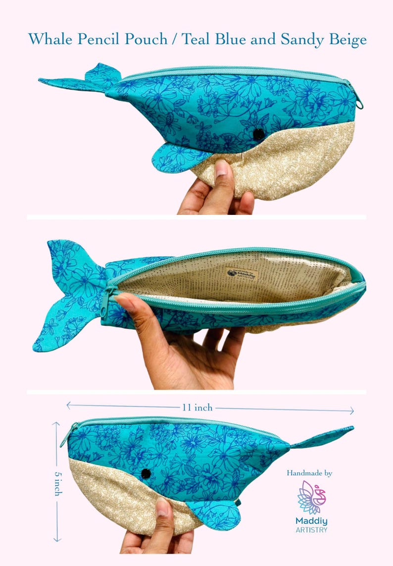 以下が含まれることがあります： 花柄のティールブルーとサンドベージュの腹部を持つ、クジラの形をしたペンケース。ジッパー開閉式で、長さ27.94cm、高さ12.7cmです。内側は明るい色の生地で裏打ちされています。