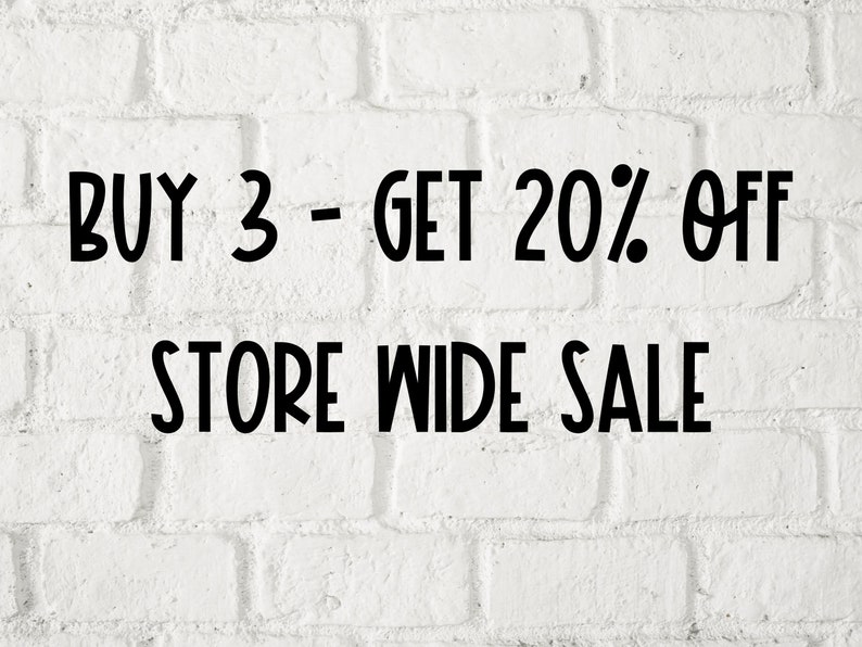 May include: White brick wall with black text that reads "BUY 3 - GET 20% OFF STORE WIDE SALE".