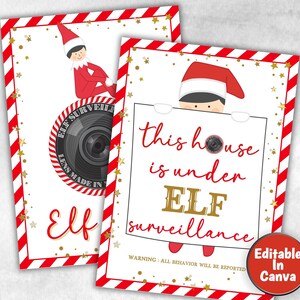 以下が含まれることがあります： カメラを持った漫画の妖精が描かれた、印刷可能なサインが2つ。最初のサインには、「妖精の監視」とカメラのレンズ、そして「レンズは〇〇製」というテキストが書かれている。2つ目のサインには、「この家は妖精の監視下にある」と、「すべての行動は報告されます」という警告が書かれている。両方のサインは、赤と白のストライプの縁取りに金色の星が描かれている。