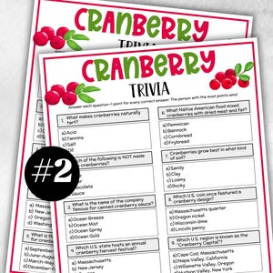 May include: Two sheets of cranberry trivia game cards with red and green text and cranberry illustrations. The top card reads "Cranberry Trivia". The cards feature multiple-choice questions about cranberries.