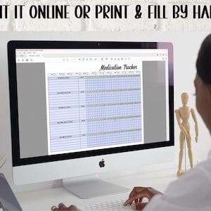 May include: A computer screen displaying a printable medication tracker. The tracker has columns for medication name, dosage, time, and days of the week. The screen is on a white desk with a plant and a wooden figurine in the background.