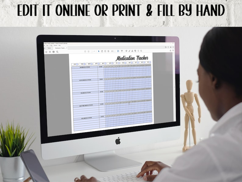 May include: A computer screen displaying a printable medication tracker. The tracker has columns for medication name, dosage, time, and days of the week. The screen is on a white desk with a plant and a wooden figurine in the background.