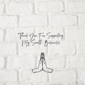 May include: A white brick wall with the text "Thank You For Supporting My Small Business." in black cursive writing. Below the text is a black and white illustration of two hands clasped together in a prayer position.