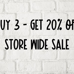 May include: White brick wall with black text that reads "BUY 3 - GET 20% OFF STORE WIDE SALE".