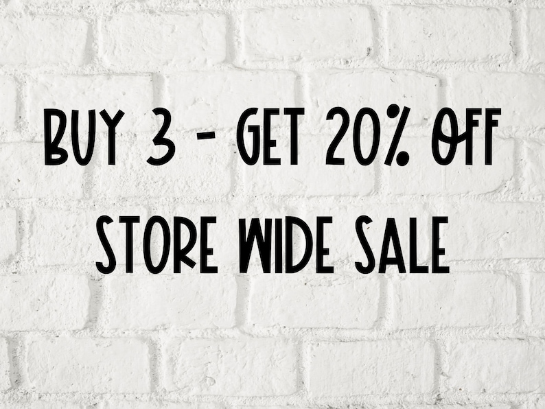 May include: White brick wall with black text that reads "BUY 3 - GET 20% OFF STORE WIDE SALE".