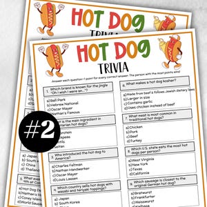 May include: Two sheets of "Hot Dog Trivia" game cards. The cards have a white background with orange and green text and cartoon hot dog illustrations. The trivia questions cover hot dog history and ingredients.