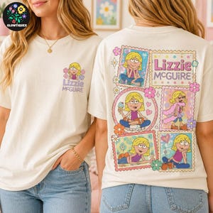 May include: An off-white t-shirt featuring a small graphic of the character Lizzie McGuire on the front left chest. The back displays a large collage of five colorful illustrations of Lizzie McGuire surrounded by flowers and the text Lizzie McGuire.