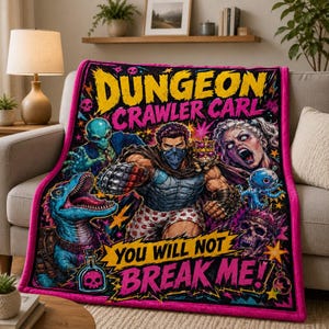 May include: A rectangular fleece blanket featuring a vibrant graphic print with the text Dungeon Crawler Carl and You Will Not Break Me. The design includes a central figure in heart-patterned boxers, a blue dinosaur, an alien, and a skull.