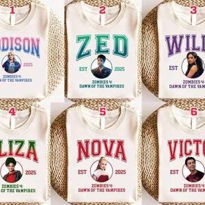 May include: Six white t-shirts with different names in bold, collegiate-style lettering. Each shirt features a circular portrait and the text "Zombies 4: Dawn of the Vampires" and the year 2025. The names are Addison, Zed, Willa, Eliza, Nova, and Victor.