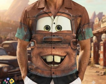 May include: A short-sleeve button-down shirt featuring a large, centered graphic of a rusty, brown tow truck character with prominent buck teeth and wide eyes. The shirt has a collared neckline and a brown, weathered texture pattern throughout.