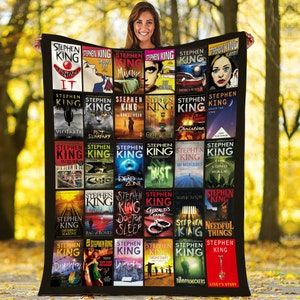 May include: A black and white quilt featuring covers of Stephen King novels. The quilt is arranged in a grid pattern with 25 squares. Each square features a different Stephen King novel cover. The quilt is a great way to show your love for Stephen King.