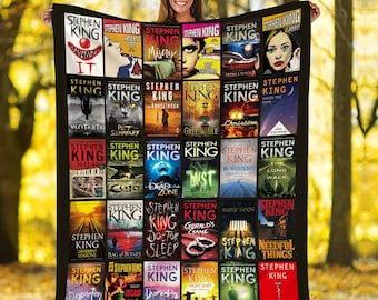 May include: A black and white quilt featuring covers of Stephen King novels. The quilt is arranged in a grid pattern with 25 squares. Each square features a different Stephen King novel cover. The quilt is a great way to show your love for Stephen King.