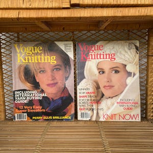 May include: Two vintage Vogue Knitting magazines. The covers feature women with blonde hair and the magazine title in yellow and red. One cover reads "12 Very Easy Super Sweaters". The other says "Knit Now!" and includes "International Yarn Buying Guide!"