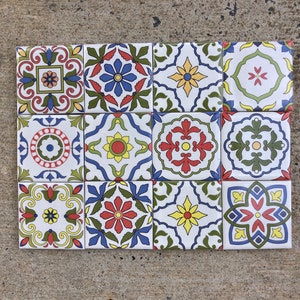 May include: A set of twelve ceramic tiles with a colourful geometric pattern. The tiles feature a variety of colours, including blue, green, red, yellow, and white. The tiles are arranged in a grid pattern.