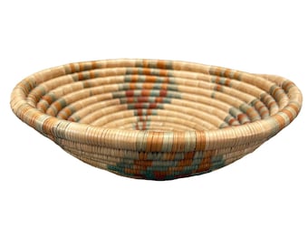 May include: A woven basket with a natural brown color and a colorful geometric pattern in shades of blue, orange, and green.