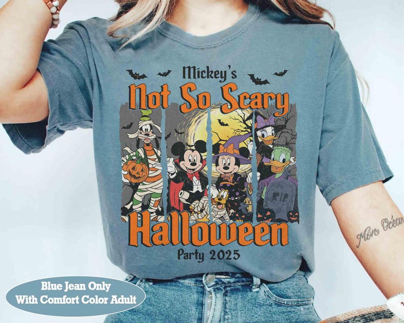 May include: Blue jean-colored t-shirt featuring a Halloween design with Mickey Mouse and friends. The graphic includes the text "Mickey's Not So Scary Halloween Party 2025". The shirt is a comfort color adult size.