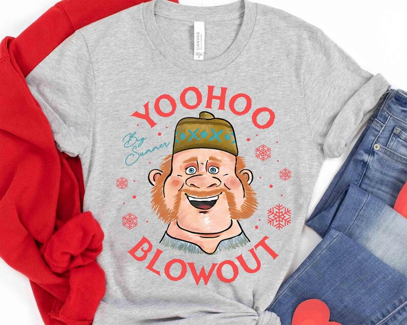 May include: A light gray t-shirt with a cartoon illustration of a smiling man wearing a hat. The text "YOO HOO BLOWOUT" is in red, with "By Sunner" in teal. Red snowflakes are scattered around the graphic.