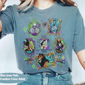 Puede incluir: Camiseta Comfort Color para adultos de color azul vaquero con retratos enmarcados de villanos animados. Los retratos est&aacute;n en marcos ornamentados con detalles y lazos coloridos. La camiseta tiene el texto "Blue Jean Only With Comfort Color Adult".
