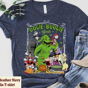 Puede incluir: Camiseta Heather Navy Bella con un gr&aacute;fico de Oogie Boogie Bash de Disney. El dise&ntilde;o incluye personajes como Jack Skellington, Oogie Boogie, Sally y otros villanos. La camiseta tambi&eacute;n tiene el texto "Disney California Adventure".
