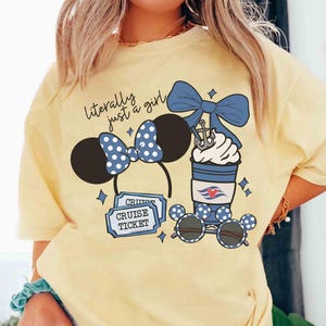 May include: Yellow t-shirt with the text "literally just a girl." The shirt features a Minnie Mouse ear headband, sunglasses, cruise tickets, and a blue bow with a nautical-themed drink.