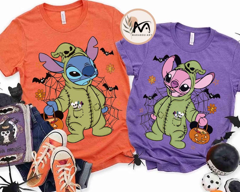May include: Two short-sleeved t-shirts, one orange and one purple, feature a cartoon character in a green costume holding a pumpkin-shaped basket. The design includes bats, spiderwebs, and flowers, perfect for Halloween.