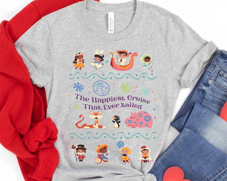 May include: A light gray t-shirt featuring a colorful graphic with the text "The Happiest Cruise That Ever Sailed." The design includes cartoon characters, flowers, and a boat. The shirt is paired with blue jeans and a red sweatshirt.