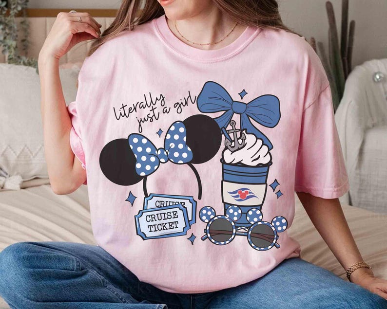 May include: Pink t-shirt with the text "literally just a girl" and graphic designs. The graphics include Minnie Mouse ears, sunglasses, a coffee cup, and cruise tickets. The Minnie Mouse ears and sunglasses have a blue and white polka dot pattern.