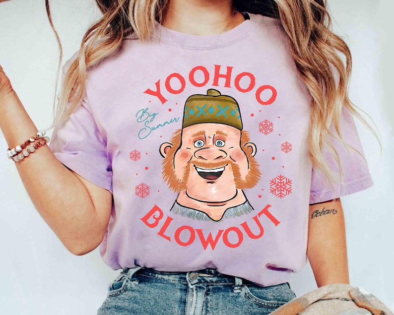 May include: A light purple t-shirt featuring a cartoon illustration of a smiling man with a beard and hat. The text "Yoohoo Blowout" is in red, with "By Summer" in cursive. Snowflake graphics are also present.