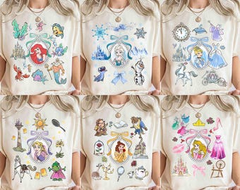 Camiseta con personajes de princesas Disney en acuarela de Coquette Bows. Personaliza la camiseta de Tiana, Ariel, Elsa, Rapunzel, Bella y Jasmine. Viaje familiar a Magic Kingdom.