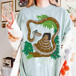 Disney Mowgli & Kaa Hypnotize Poster Retro Shirt, Disney The Jungle Book Characters Tee, Disneyland Family 2025 Trip, WDW Vacation Shirt